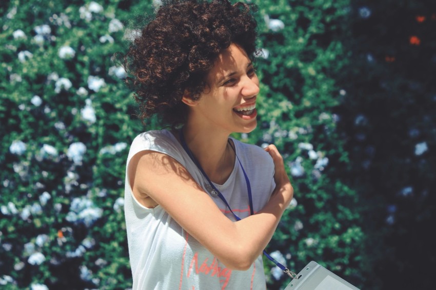 woman standing beside green plants SKFdd8JGU