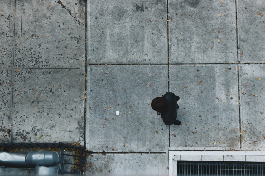 aerial photography of person standing near concrete building Wh U6