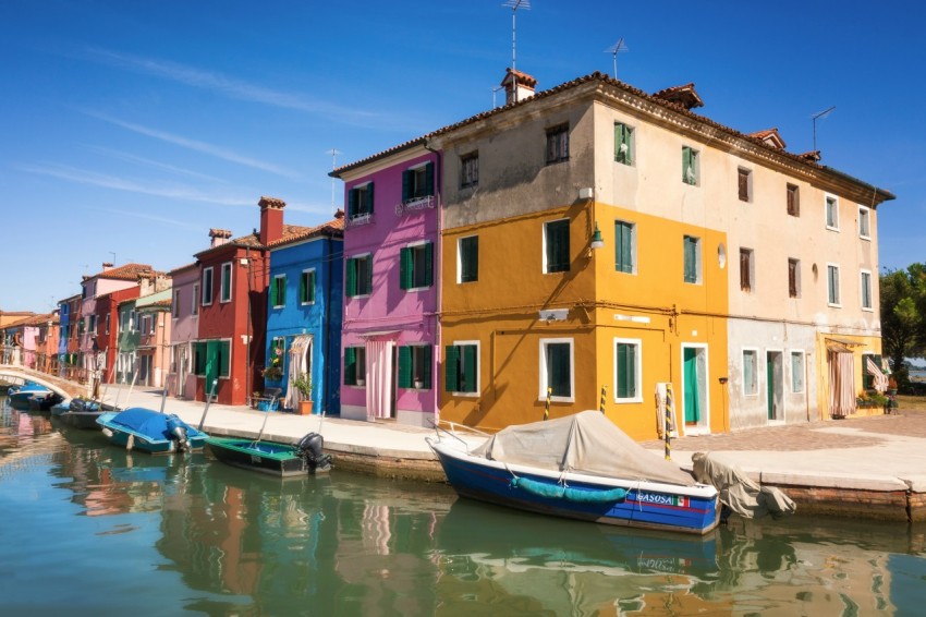 boats near concrete building during daytime