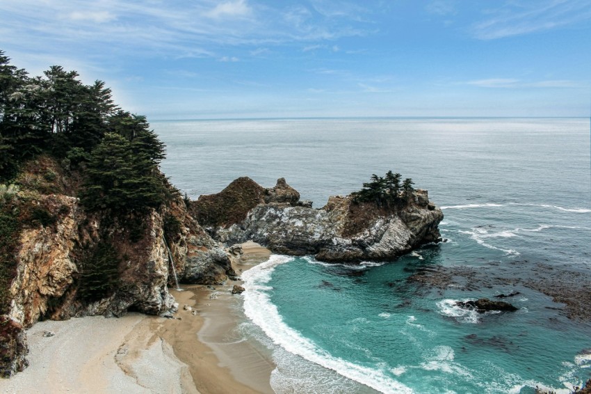 high angle photo of green sea near white sand beach