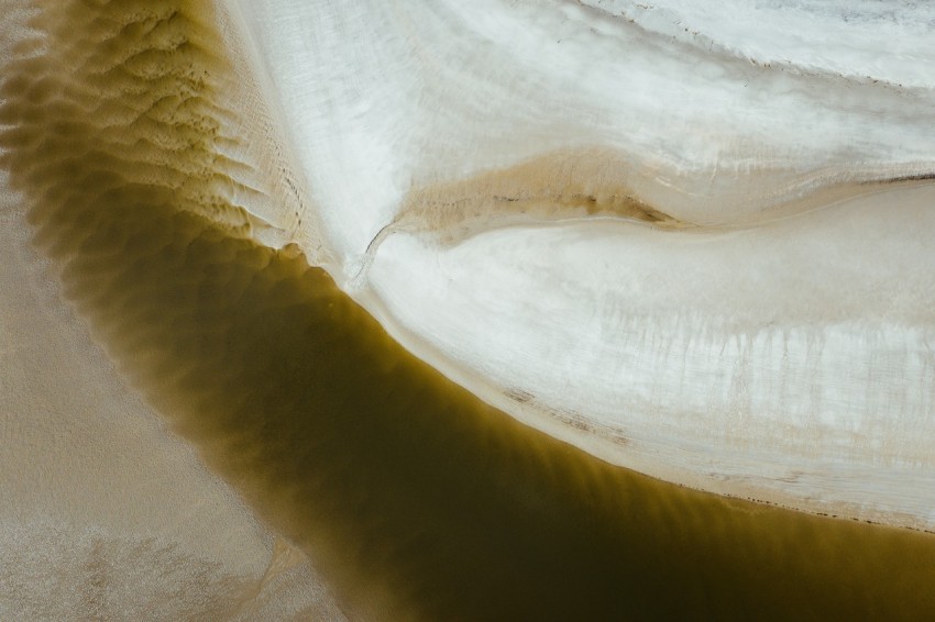 an aerial view of a river with water flowing over it