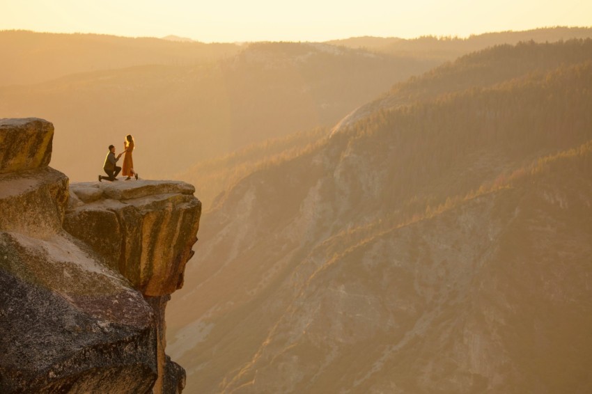 person sitting on rock formation during daytime