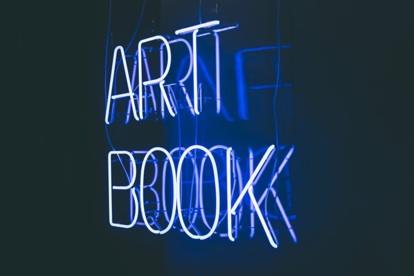 a neon sign that reads art book