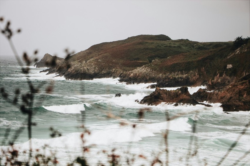 photography of mountain range and seashore during daytime