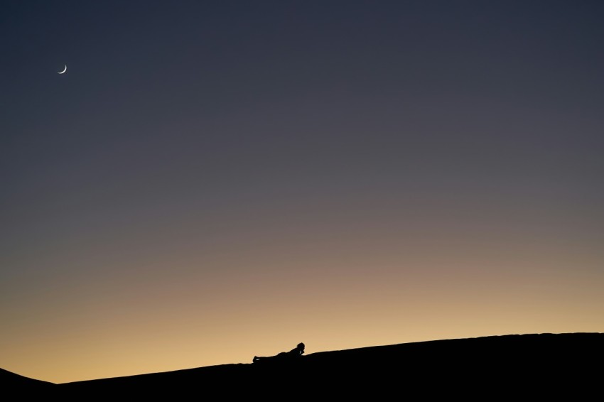 silhouette photo of mountains and moon