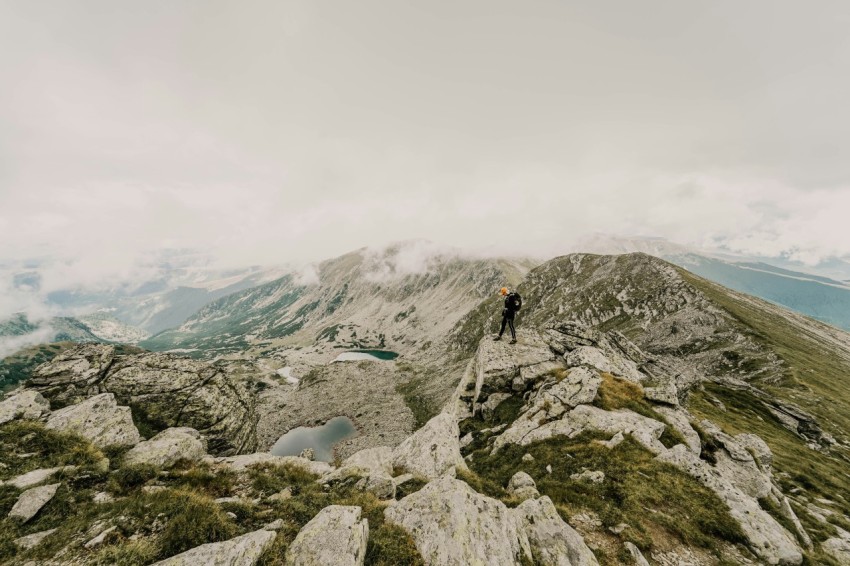 person standing on cliff during daytime