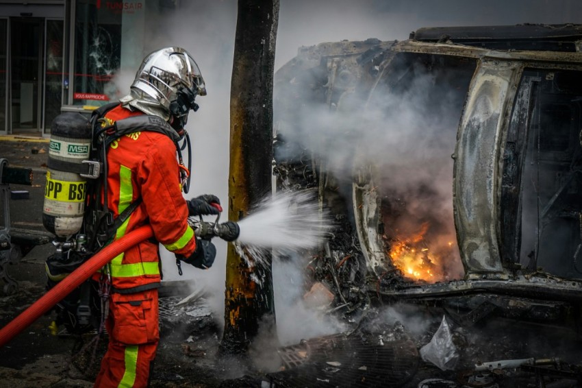 fire fighter bombing the burning vehicle with water