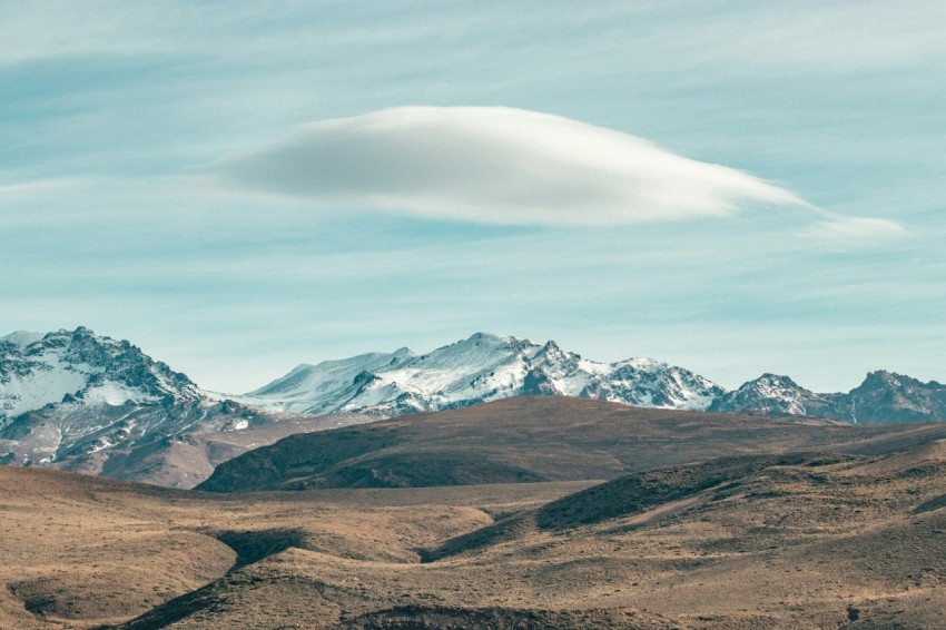 brown and white mountains under white clouds during daytime