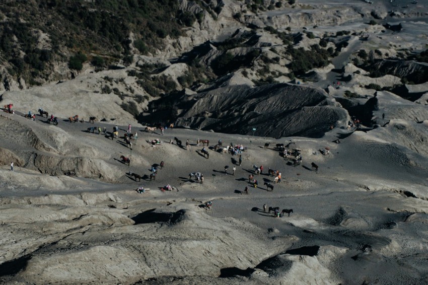 aerial photography of people standing on gray rocky mountain during daytime ICTASeUu