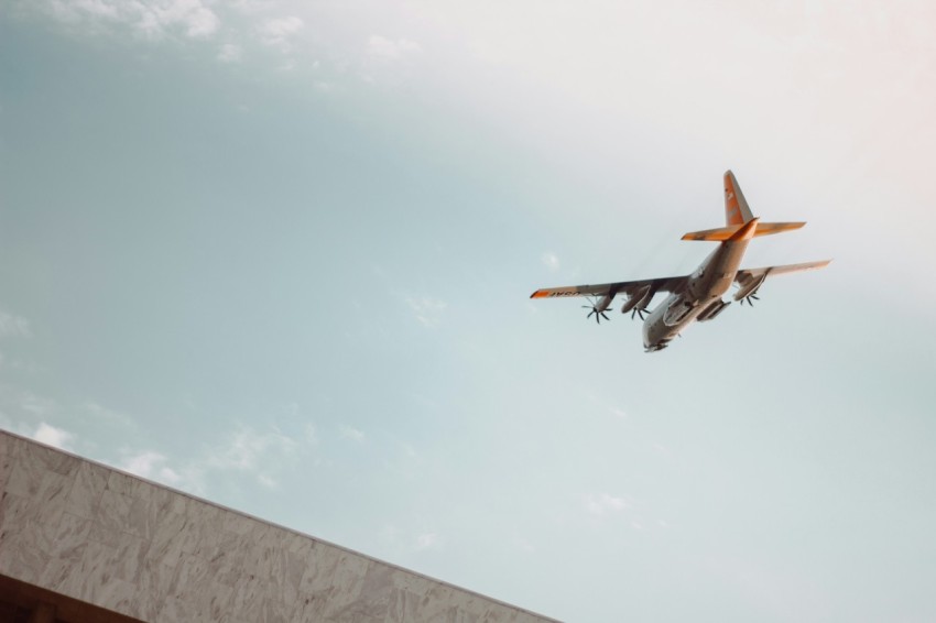 white airplane under cloudy sky during daytime