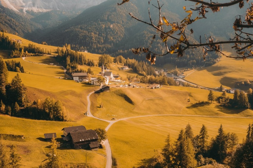 aerial photography of houses on green field viewing mountain during daytime 0Rd9G2P