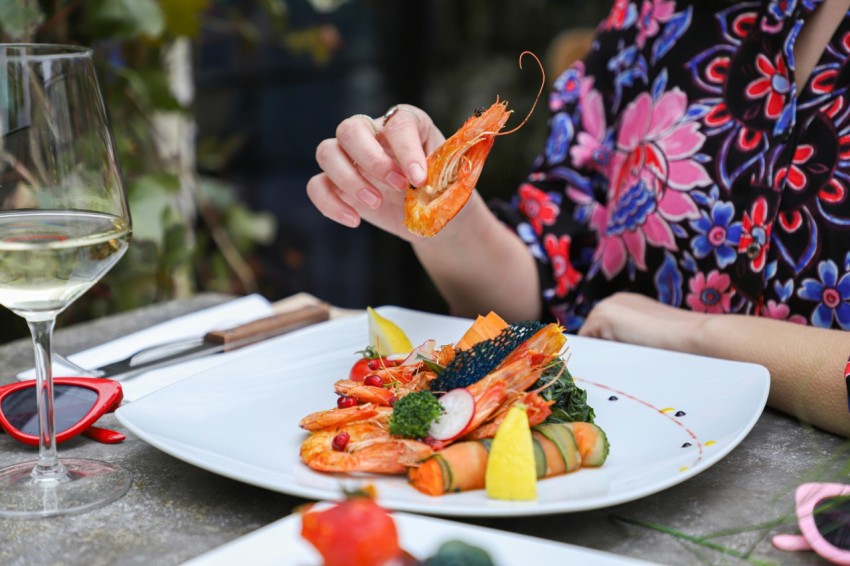 a woman is cutting a carrot