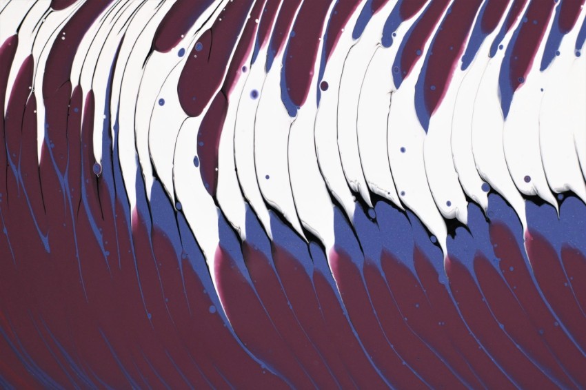 a close up of a red and white wave