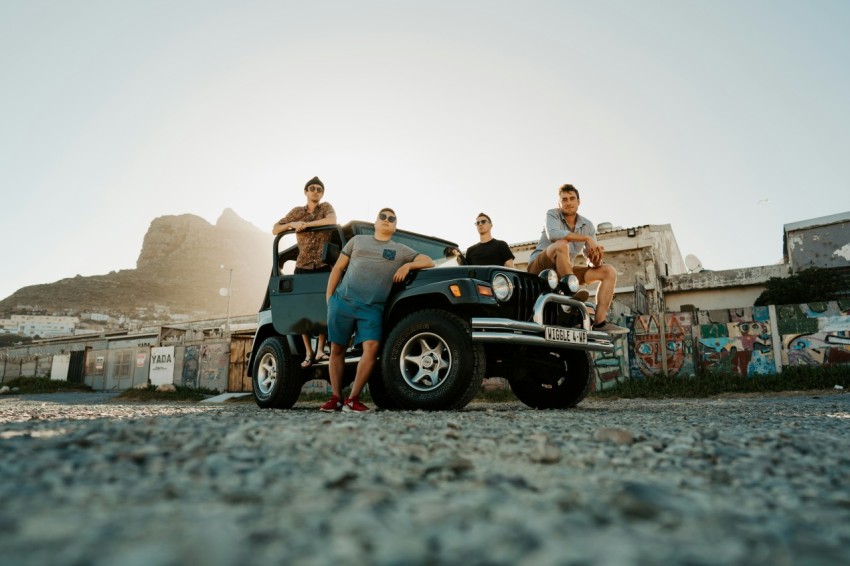 couple sitting on blue and white jeep wrangler