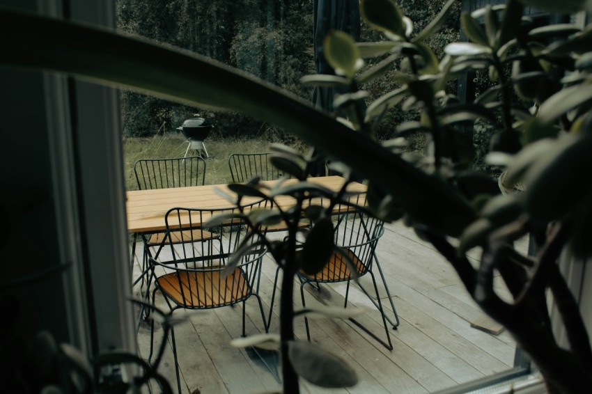 a table and chairs on a wooden deck