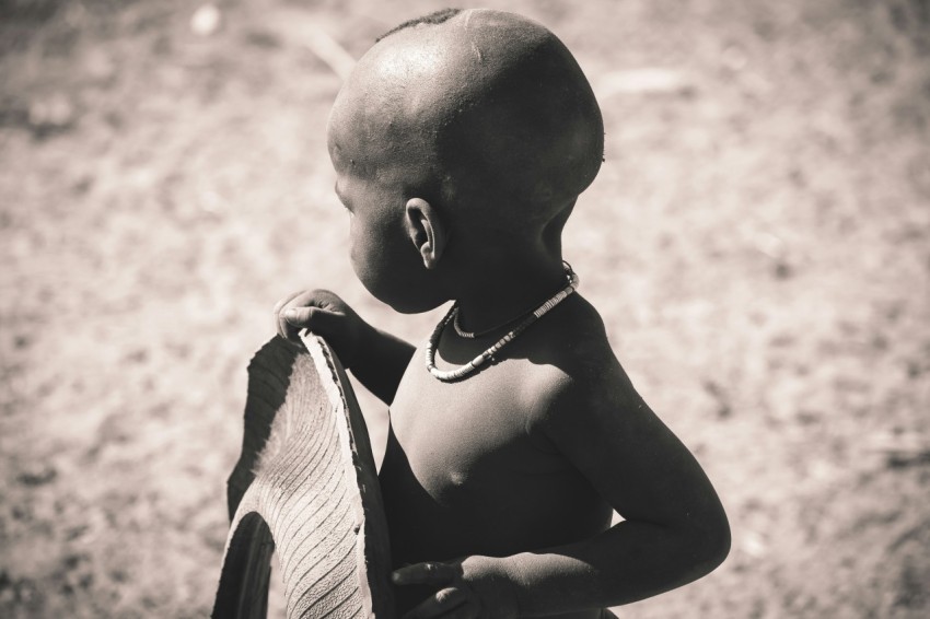 grayscale focus photo of children holding tire Ryeu