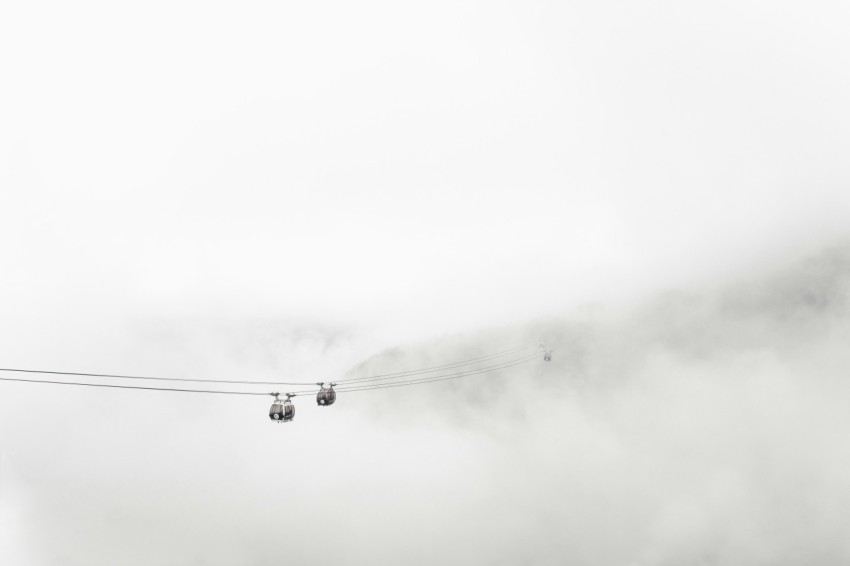 black cable car under white clouds oy