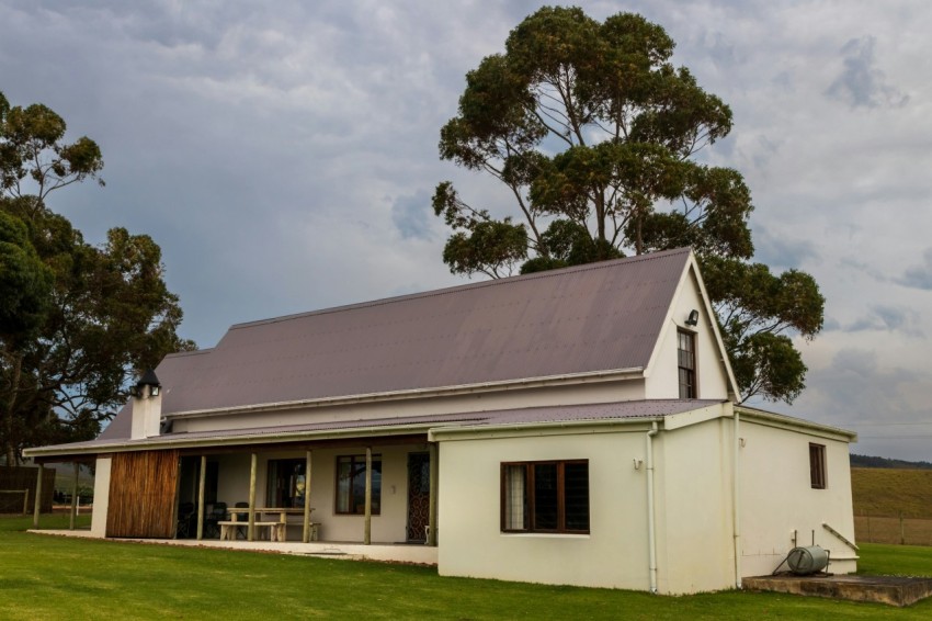 a house with a lawn and trees N