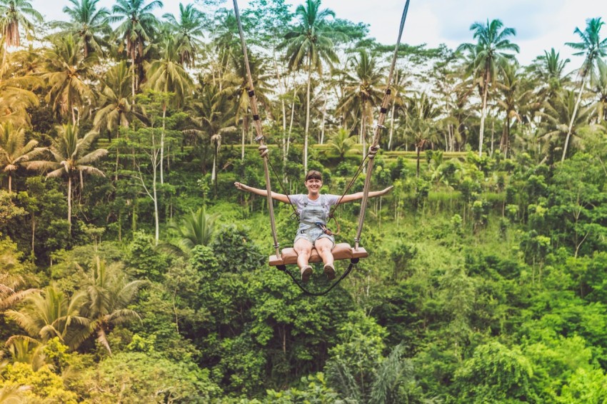 woman in gray t shirt seating on zipline