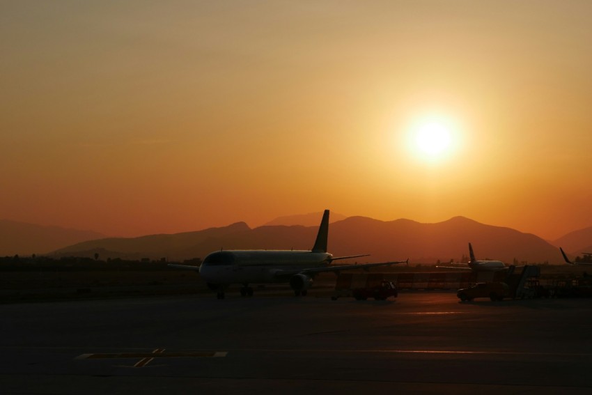 white passenger plane on airport during sunset R