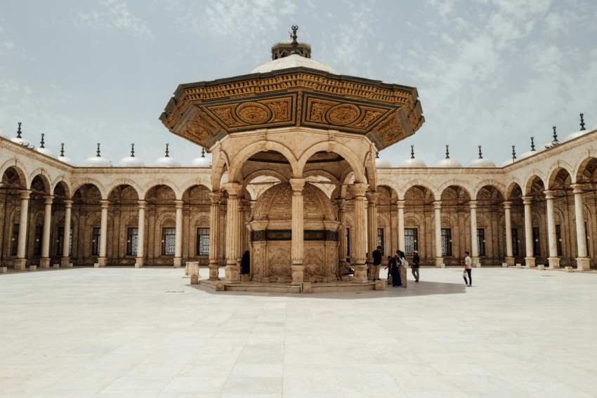 a large courtyard with arches and arches around it