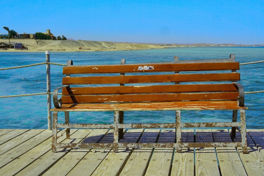 a wooden bench sitting on top of a wooden pier