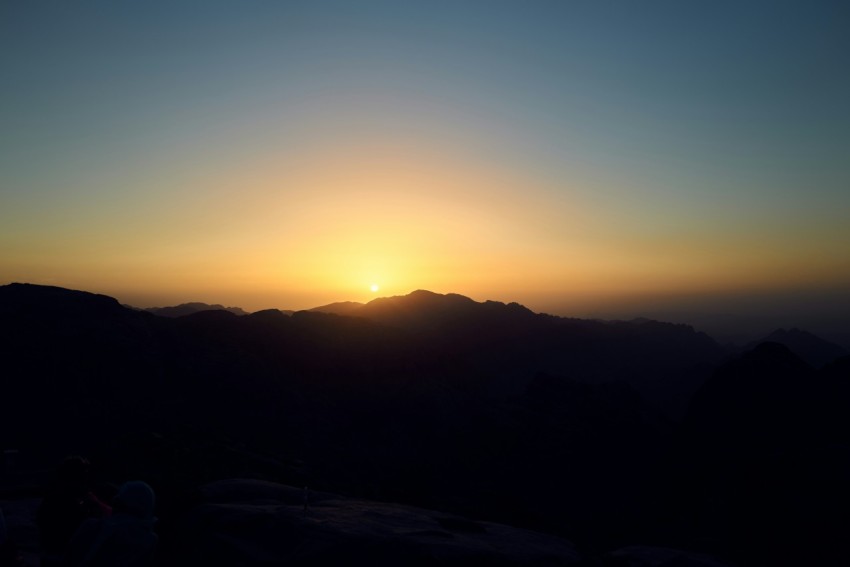 a sunset over a mountain range