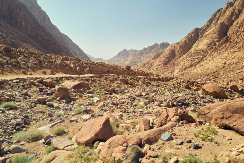 a rocky area with mountains in the background