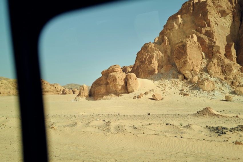 a desert landscape with a rock formation