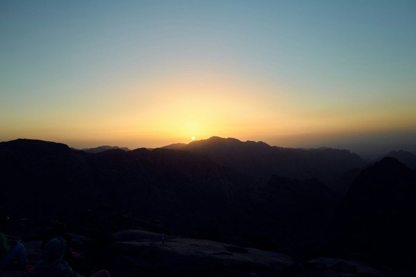 a sunset over a mountain range