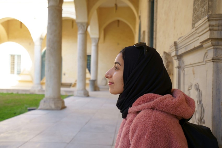 woman in black hijab and pink robe