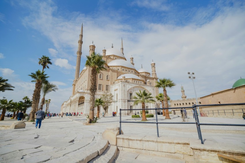 a large white building with a green dome