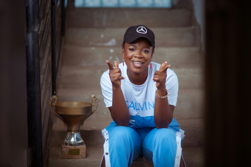 a woman sitting on the steps with a trophy