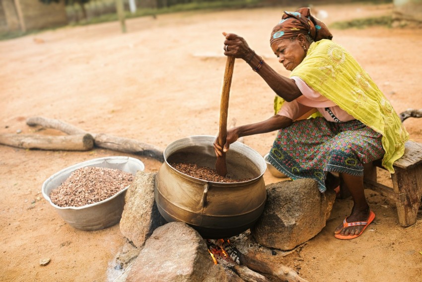 a person cooking food in a wok