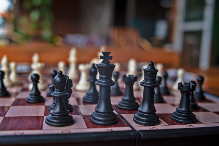 a close up of a chess board with pieces on it