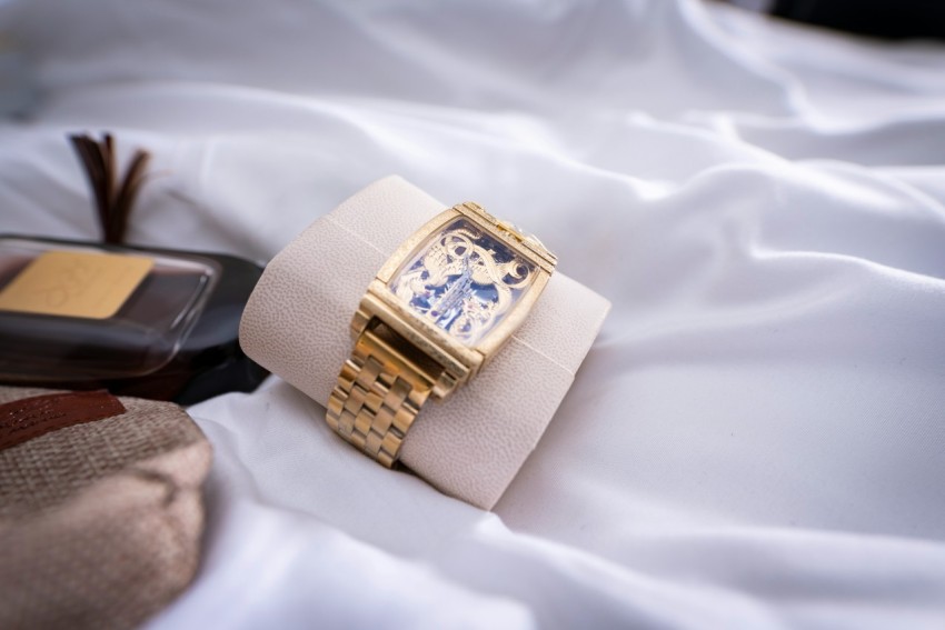 a gold ring on a white cloth