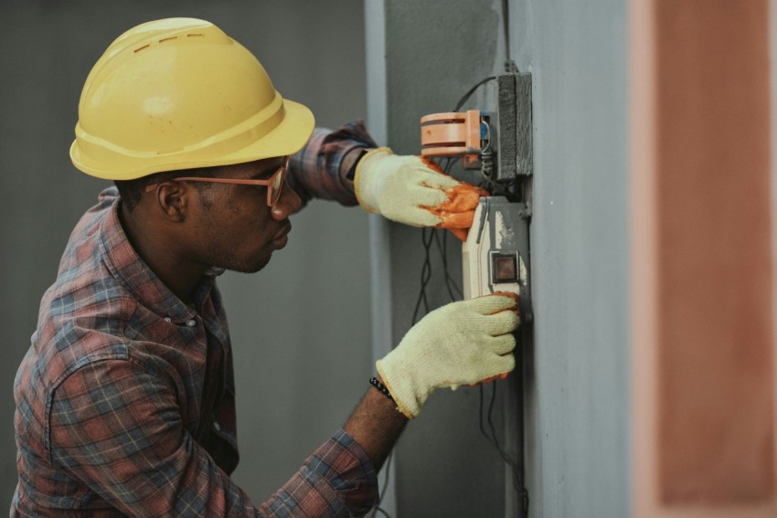 man in brown hat holding black and gray power tool _2AlIm