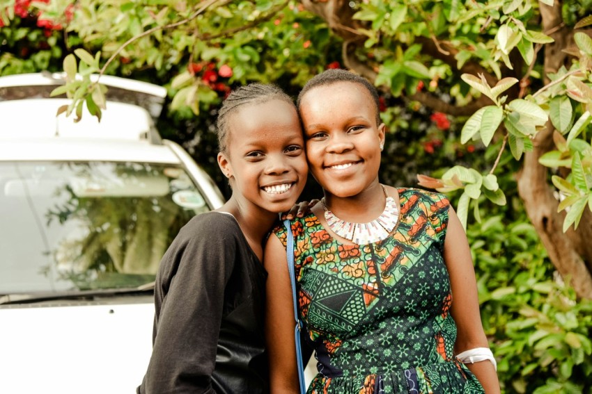 a couple of young girls standing next to each other