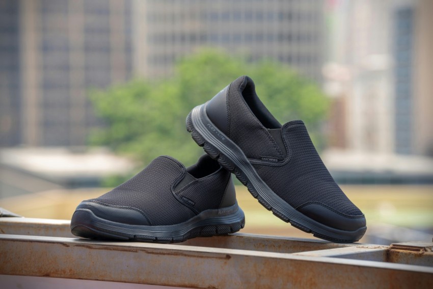 a pair of gray shoes sitting on top of a metal rail 41xStJbm