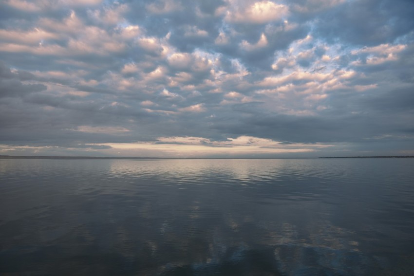 blue sea under blue sky and white clouds during daytime