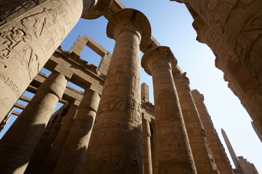 a group of pillars in a building with a sky background 1e