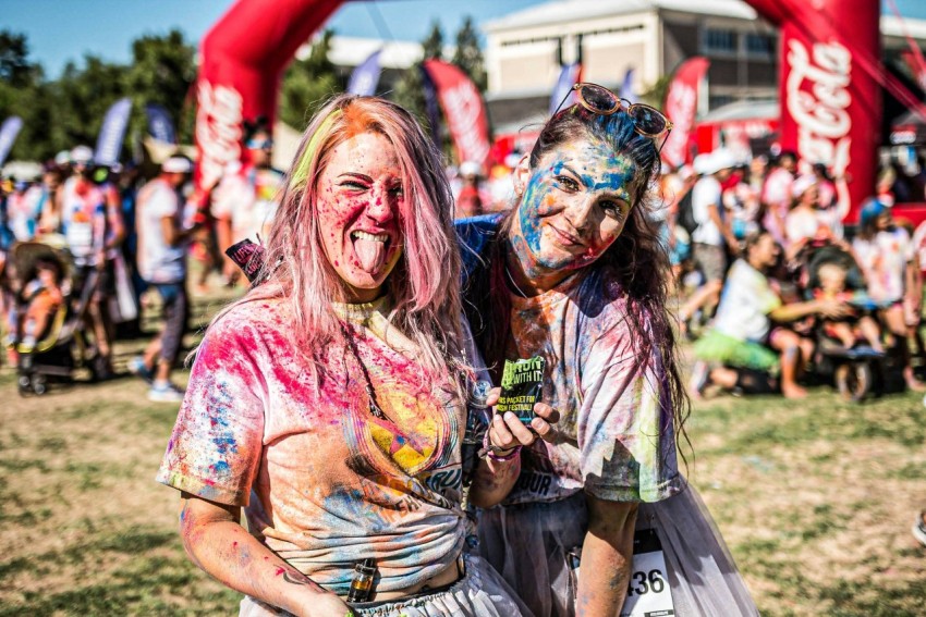 woman in pink and white floral shirt with face paint