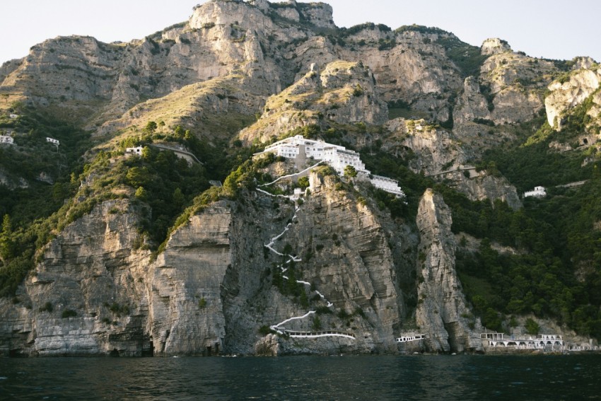 a large mountain with a house on top of it