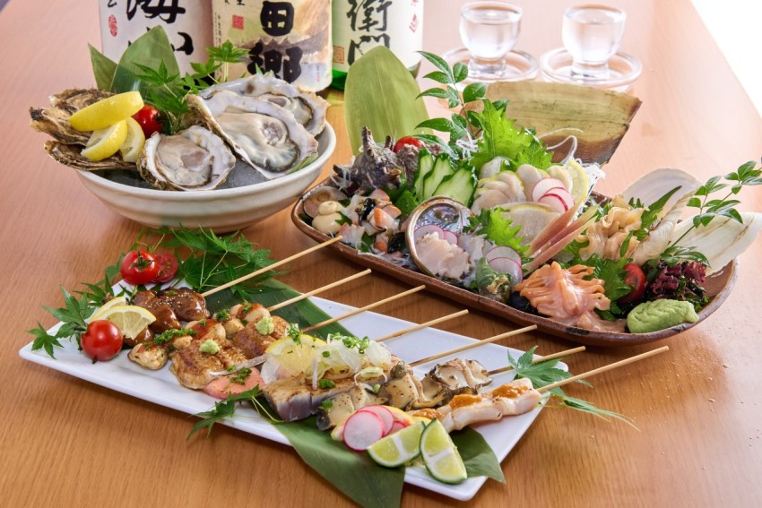 a wooden table topped with plates of food