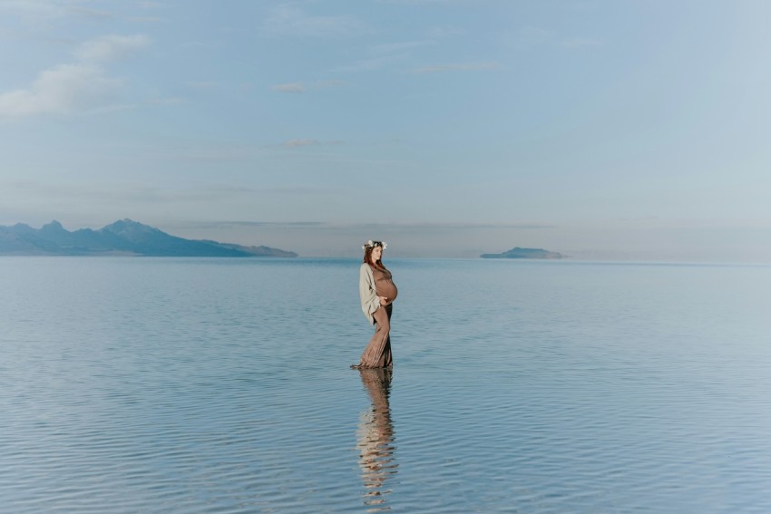 woman standing on beach Qc1