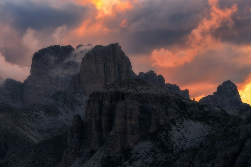 the sun is setting behind a mountain range