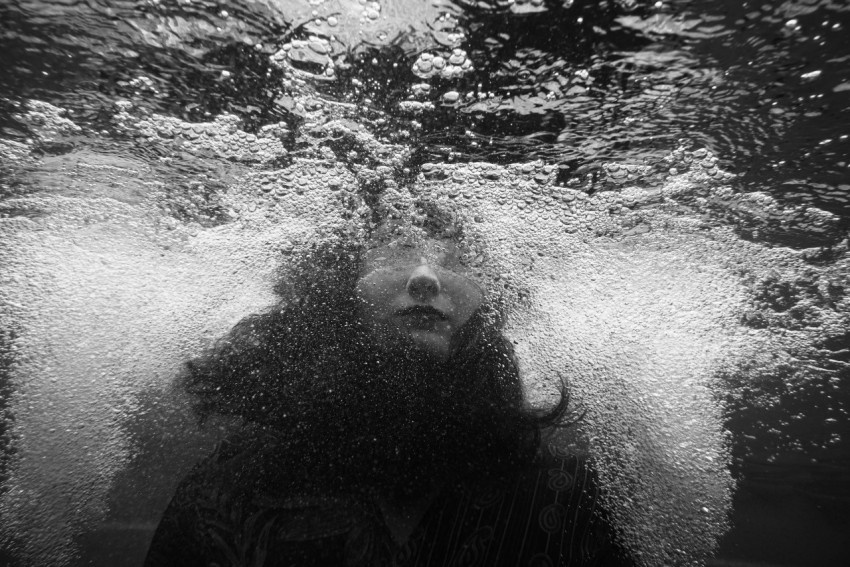 grayscale photo of person underwater