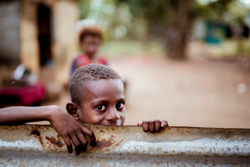 boy holding corrugated sheet PAiVzSmYy