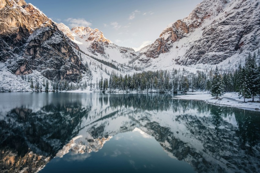 snow covered mountain near lake during daytime