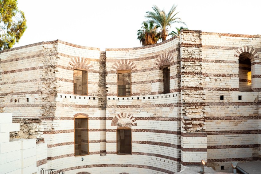 a large brick building with a clock on its side